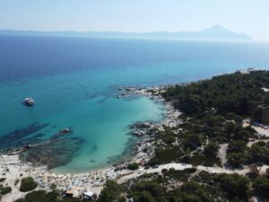 Helder turquoise strand met bootje aan de kust bij Thessaloniki in Halkidiki